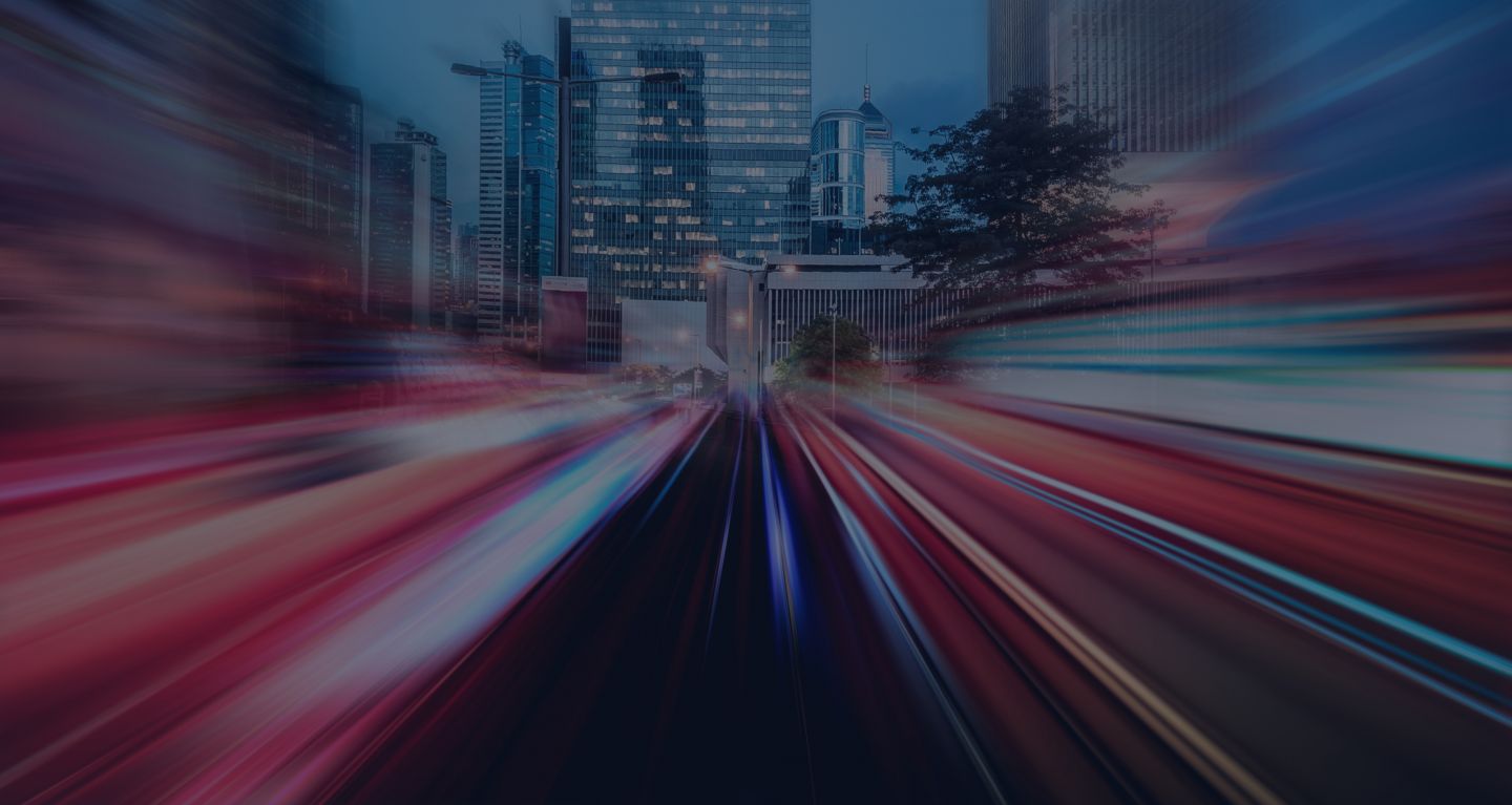 A blurry image of a city with skyscrapers in the back